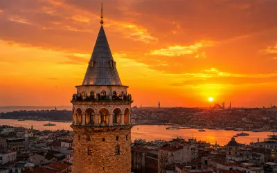 The Galata Tower rising above the rooftops of Karakoy at sunset