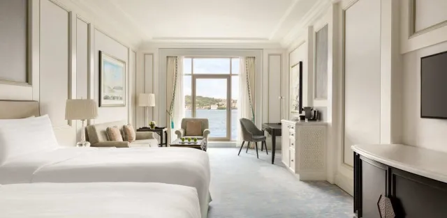 A luxury waterfront hotel terrace directly on the Bosphorus at sunset