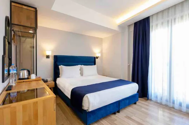 A hotel rooftop terrace overlooking the Golden Horn and Galata Tower