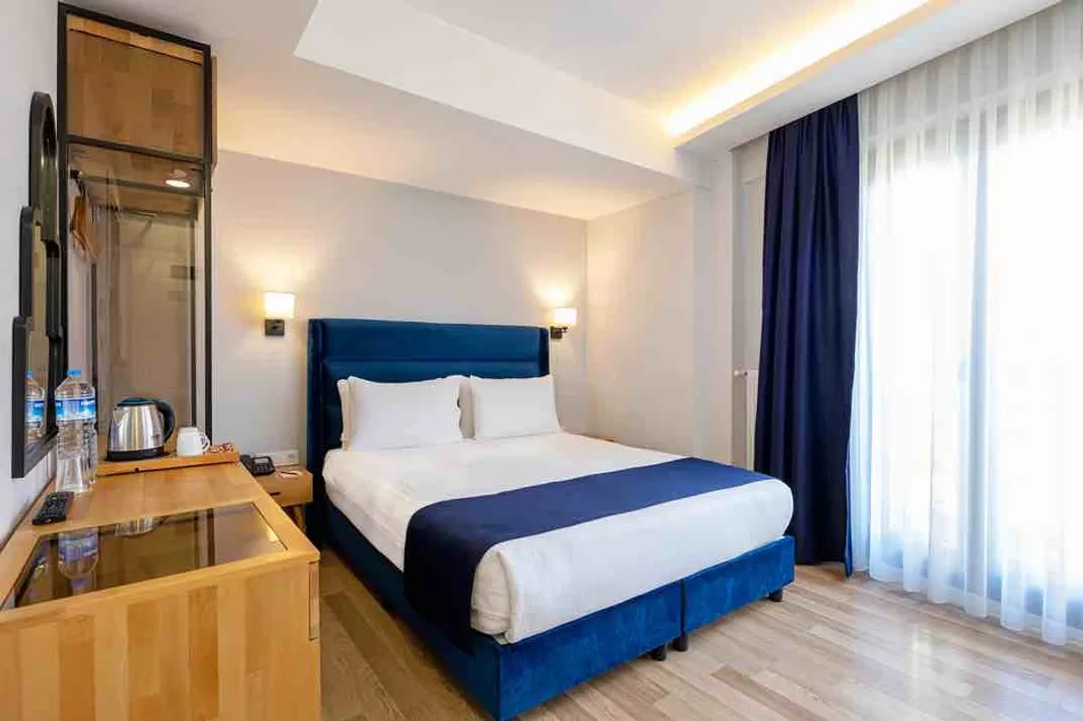 A hotel rooftop terrace overlooking the Golden Horn and Galata Tower