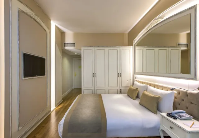 A boutique hotel courtyard with a view of Hagia Sophia's dome in the distance